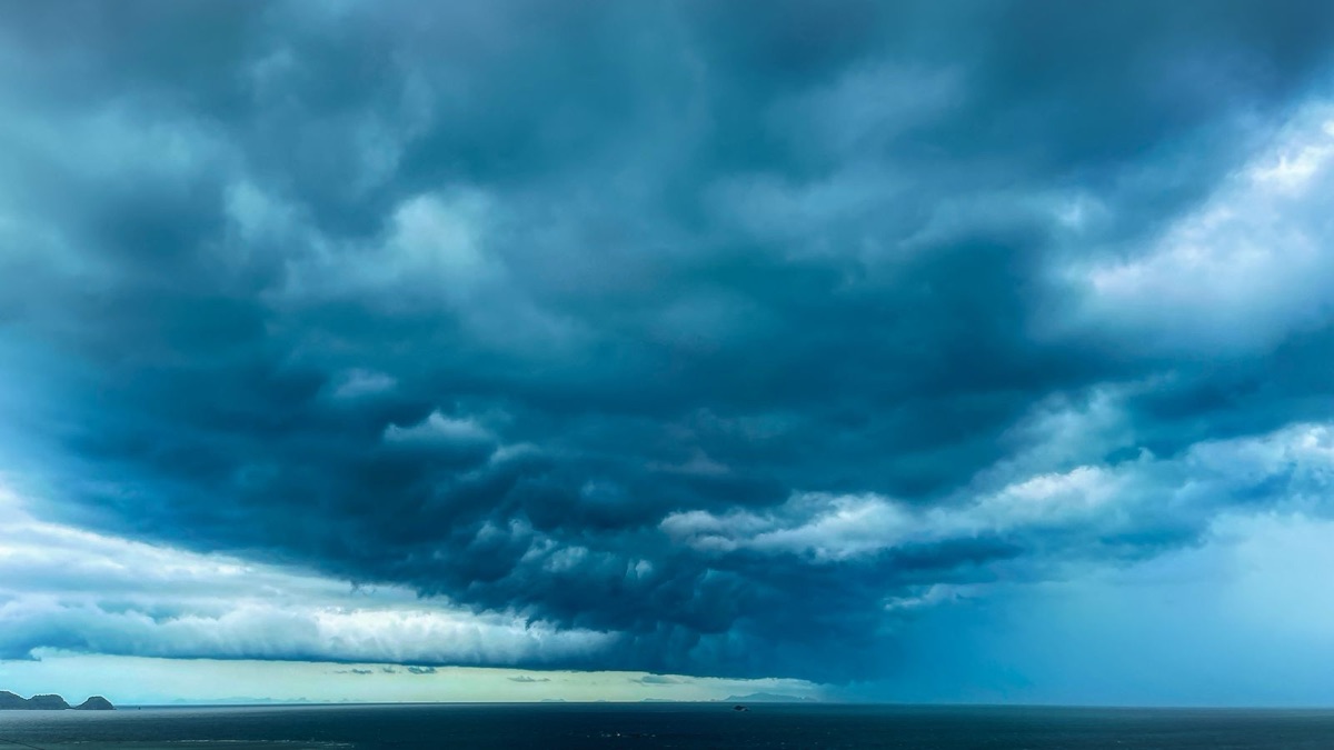 Dark storm cloud formation looming over the ocean